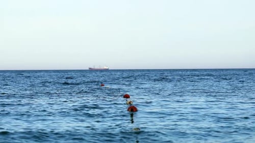 Floating buoy on blue sea. Lots of empty red mooring buoys floating on water