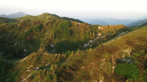 Flying over the hills and mountains at sunrise