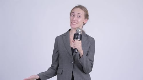 Woman Talking Into Microphone With Hand Gestures
