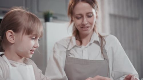 Mom And Daughter Cooking During Lockdown