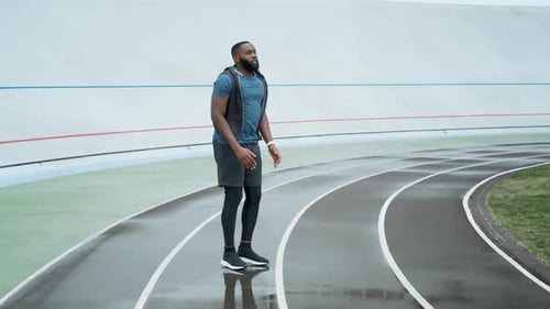 Sportsman Doing High Jumps on Place at Stadium. Athlete Training on Sports Track