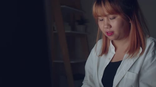 Woman Works on Computer Late at Night