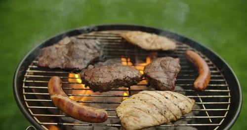 Meat Sizzling on Outdoor Grill