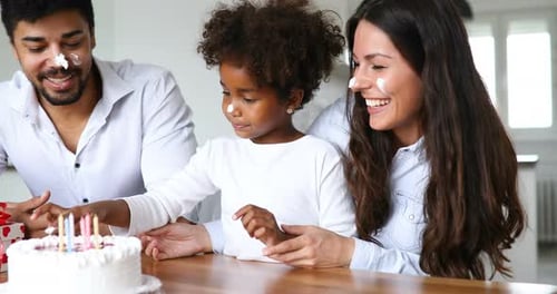 Happy Family Celebrates Birthday with Cake