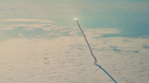 Dramatic Rocket Launch Above the Clouds