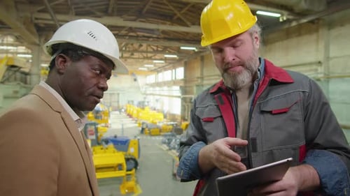 Factory Technician and Engineer Discussing Something on Tablet