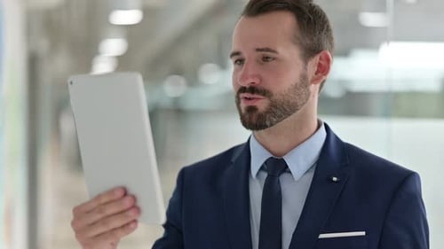 Business Man Video Conference on Tablet in Office