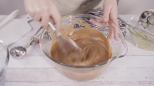 Mixing ingredients to bake chocolate raspberry cupcakes.