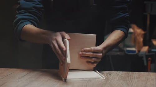 Craftsperson Shaping Wood in Workshop