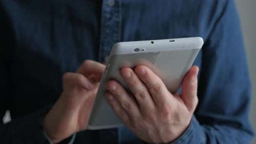 Close Up of Man Using White Tablet