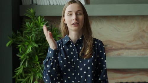 Woman Speaking Directly to Camera Indoors