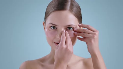 Woman Applying Under Eye Skin Patches