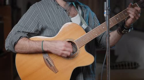 Man playing acoustic guitar and singing