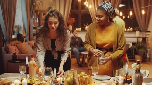Two Women Preparing Party Table for Friends