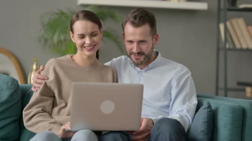 Couple Video Chatting on Laptop at Home Together