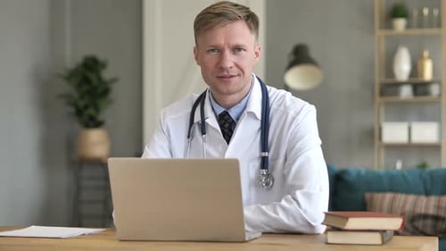 Smiling Positive Doctor At Work Looking at Camera