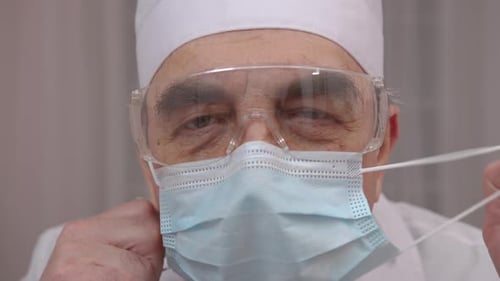 Medical Professional Removing Face Mask Close Up