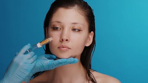 Woman Receives Injectable Facial Treatment with Gloved Hands