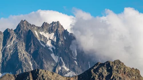 Puffy clouds over the mountains.