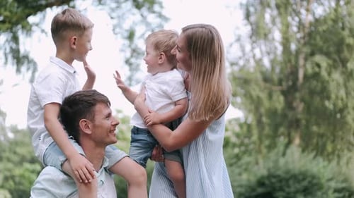 Happy Family Posing in a Sunny Park