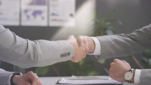 Business Agreement: Handshake in an Office Setting