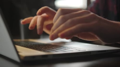 Hands Typing on a Laptop Keyboard Close Up