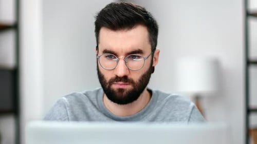 Bearded Man Wearing Glasses Working at Computer