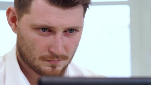 Male Manager Works on Computer