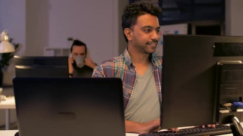 Indian Man with Computers Working at Night Office 45