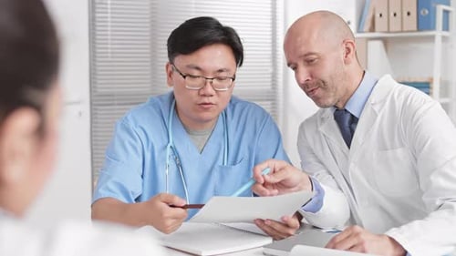 Medical Team Discussing Patient Care in Office