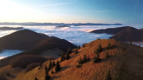 Majestic Mountain Vista: Solitary Figure Overlooking Clouds