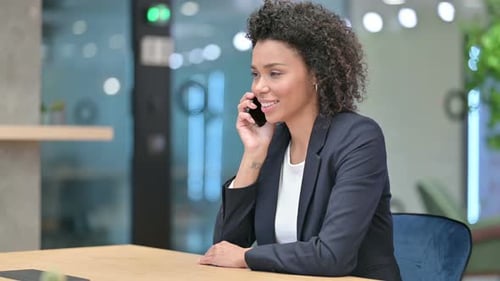 Woman Smiling, Talking on Phone in Office