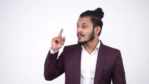 Happy Indian businessman got an idea and starts smiling