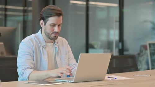 Excited Man Celebrating Success on Laptop