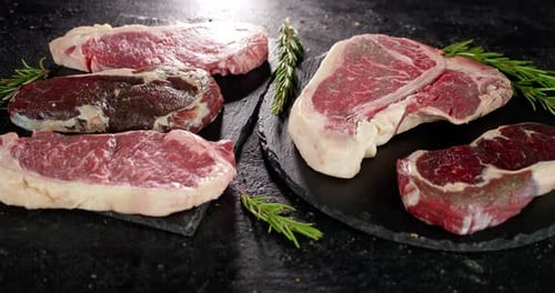 Raw Beef Steaks Displayed with Rosemary