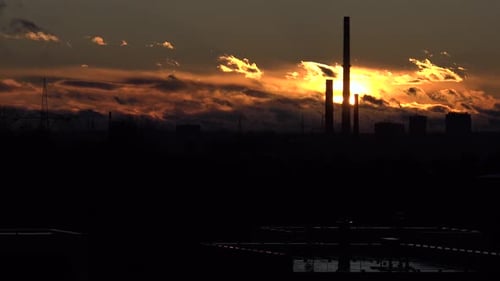 Skylines of an Urban Area Stand Against the Golden Sunrise - Timelapse