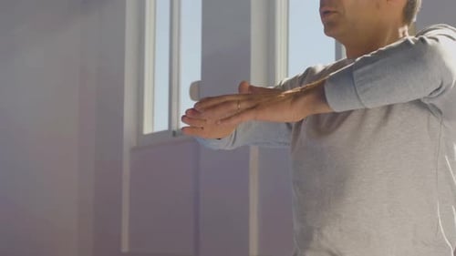 Adult Male Practicing Yoga in Bright Studio
