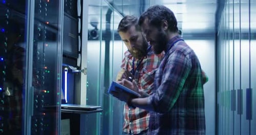 Coworking Men in Modern Server Room of Data Center