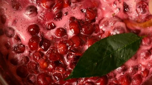 Preparation of Sweet Cherry Confiture and Mixing It with Wooden Spoon. Top View, Top Down Food.