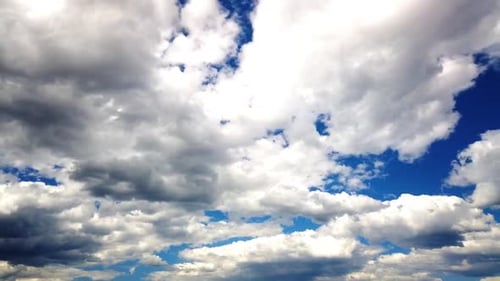 Majestic Cumulus Clouds Moving Across a Blue Sky