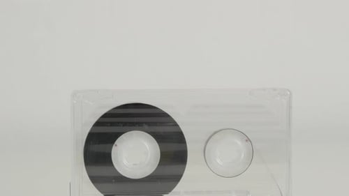 Analogue magnetic audio tape on white 4K 2160p 30fps UltraHD tilting footage - Close-up of retro st