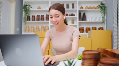 Portrait of Asian beautiful woman selling vase product online at home.