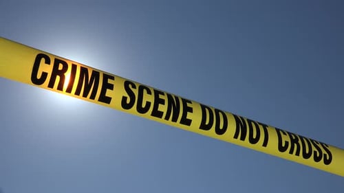 Crime Scene Tape Against Blue Sky