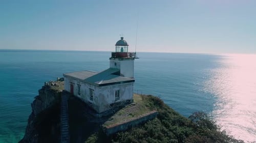 Aerial Panoramic View of White Lighthouse on the Rocky Cliff at Seaside