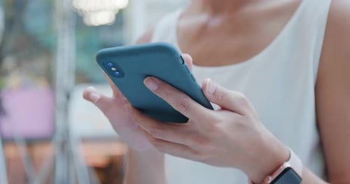 Hands Using Smartphone in Urban Setting