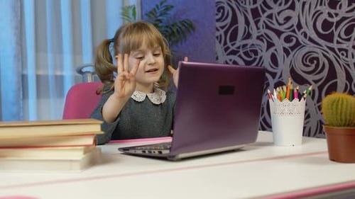 Girl Studying Online with Laptop Computer at Home
