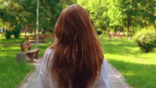 Unrecognizable Female Stroll in Park