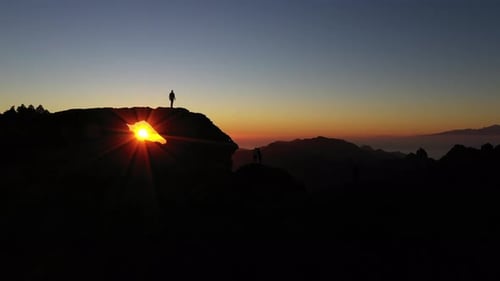 Silhouetted People On Mountain Watching Sunset