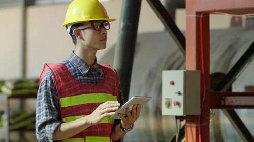 Engineer Using Tablet In Factory