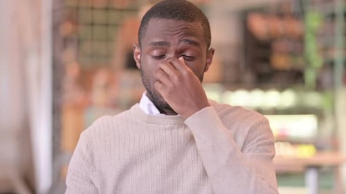 Portrait of Exhausted African Man Having Headache